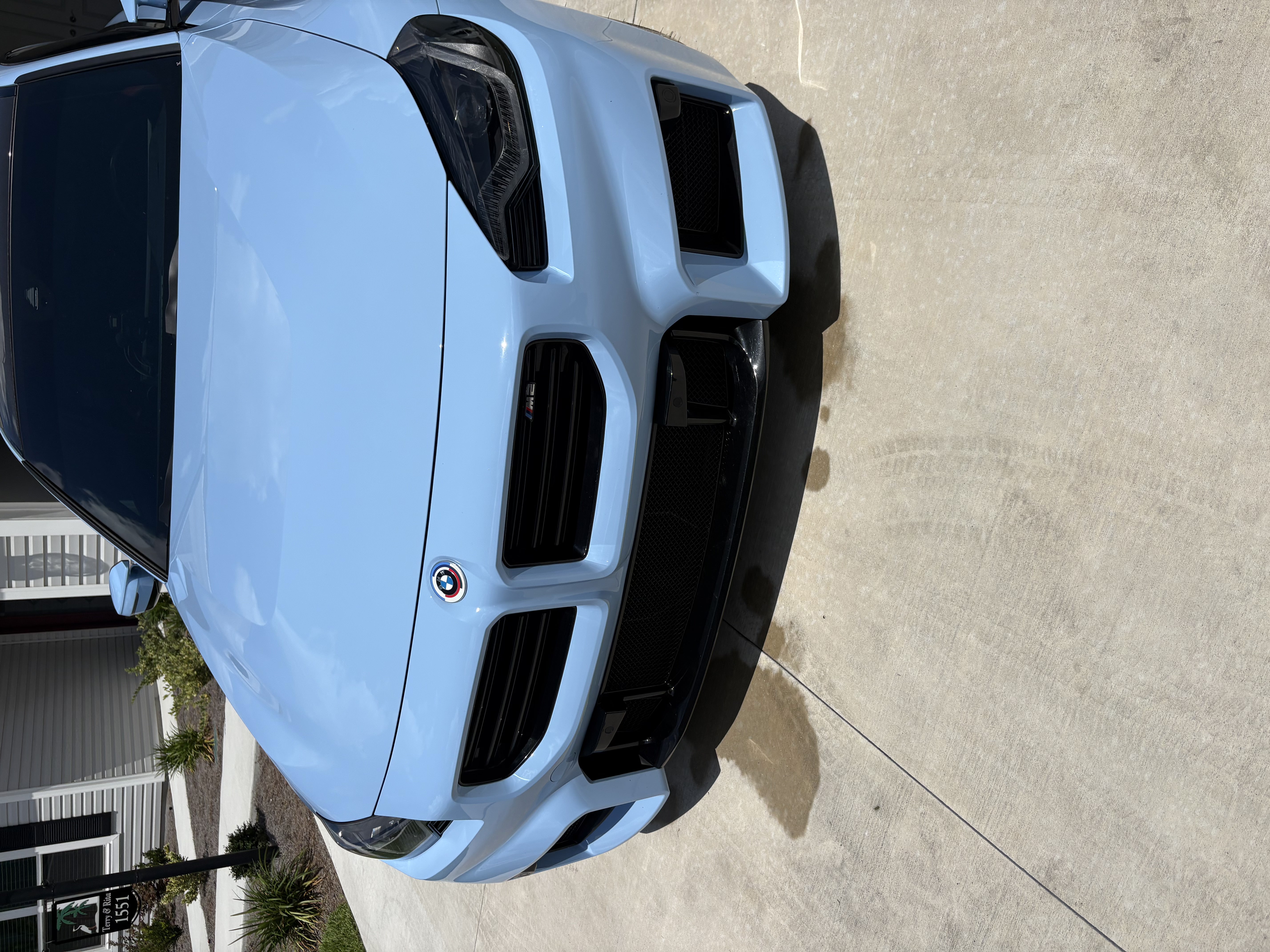 Baby blue BMW M2 front end gleaming after a mobile detail in Lake County, FL