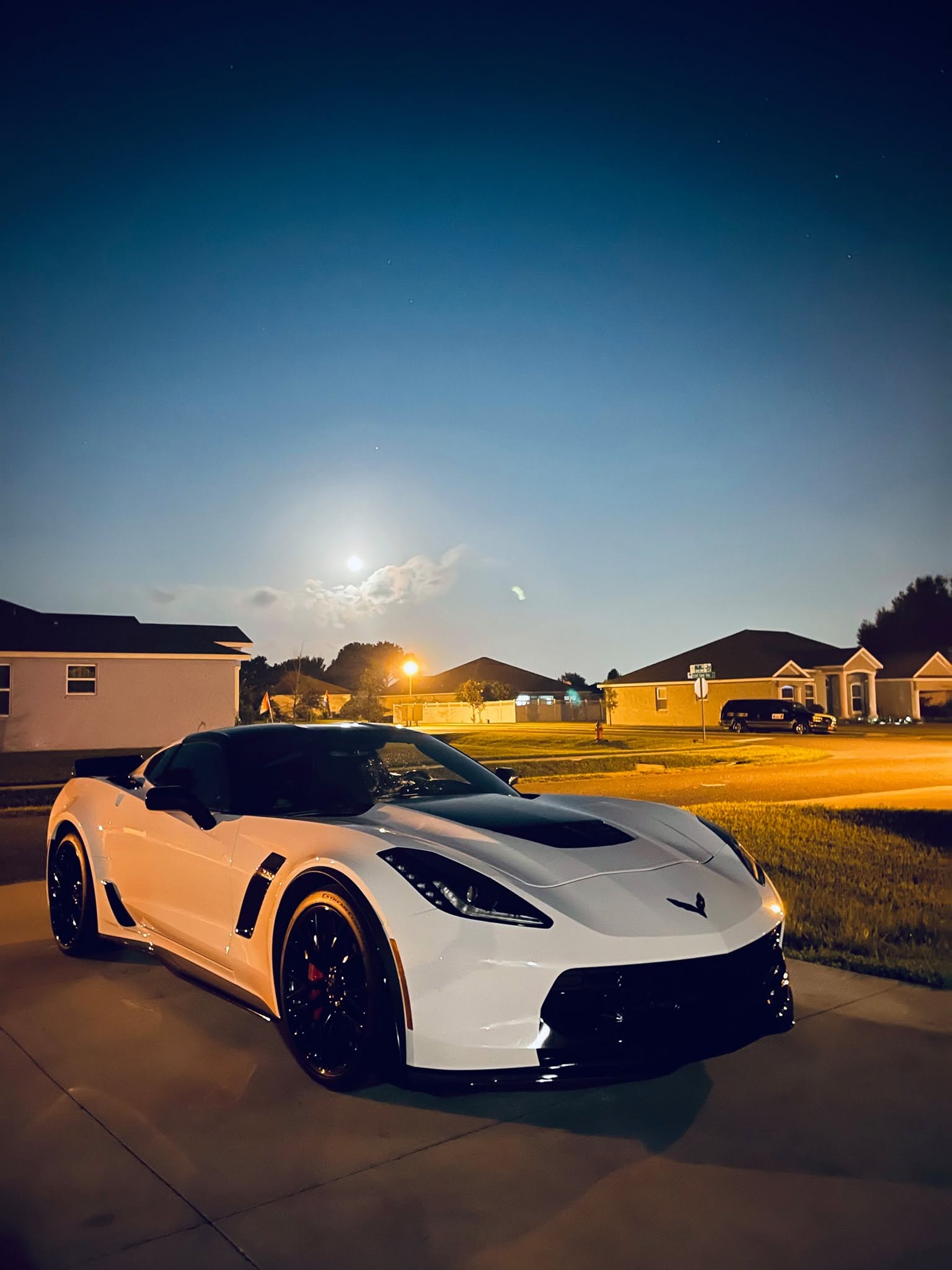 White Corvette Z06 with show-car finish at dusk