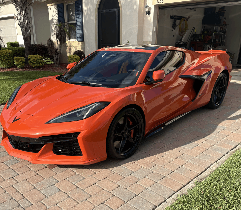 Orange Chevrolet Corvette C8 gleaming after a mobile detail in a Lake County, FL driveway